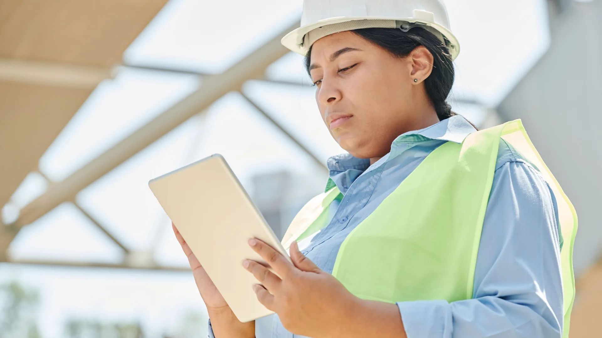 HSE professional using a digital tablet while wearing protective equipment